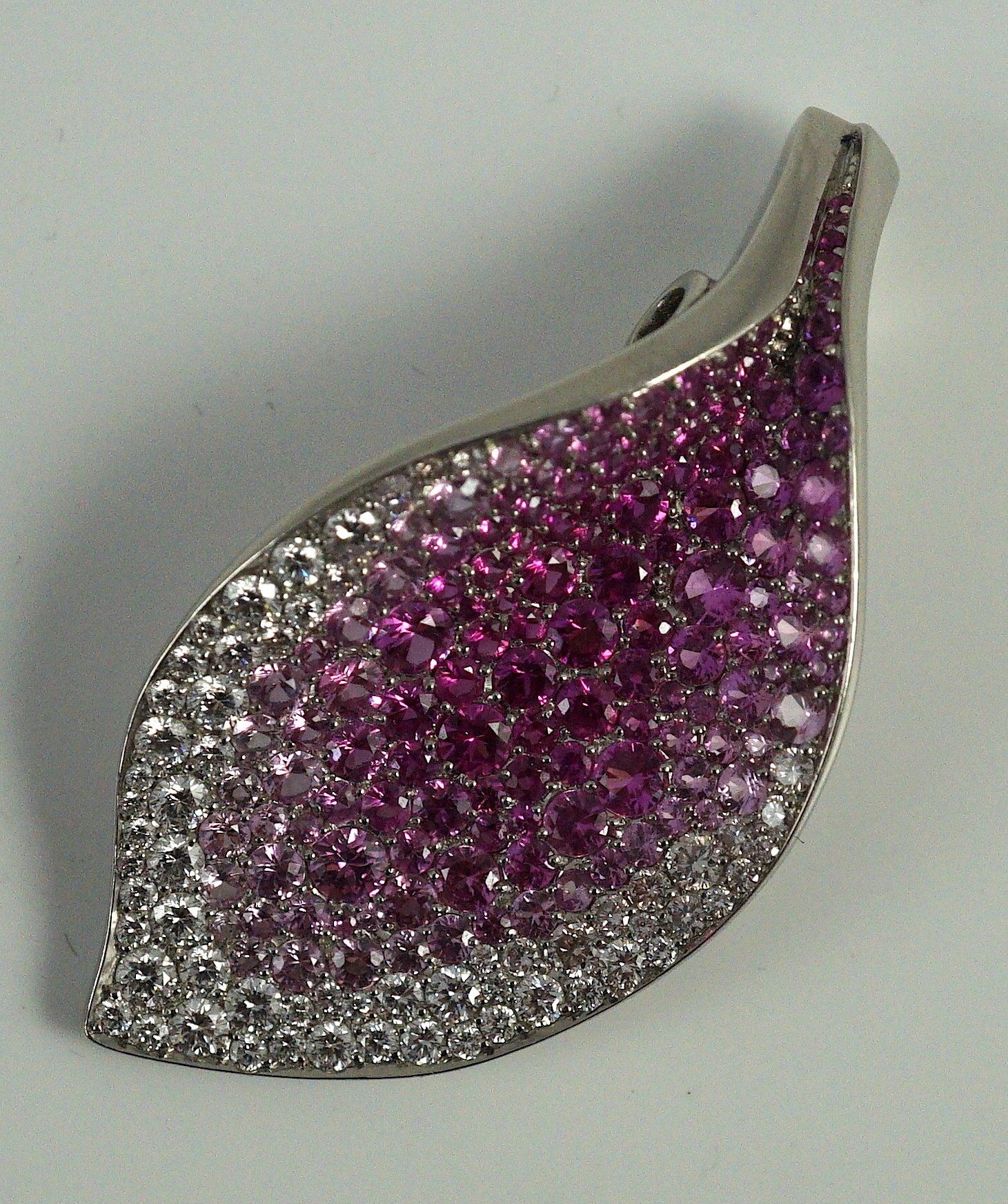 A modern Paspaley platinum and gypsy set pink and white diamond and pink sapphire cluster set leaf shaped enhancer pendant, from their Paradis collection